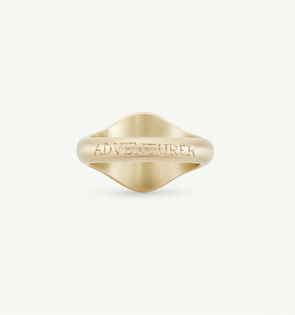 Gold ring featuring the word "ADVENTURER" engraved on its surface.