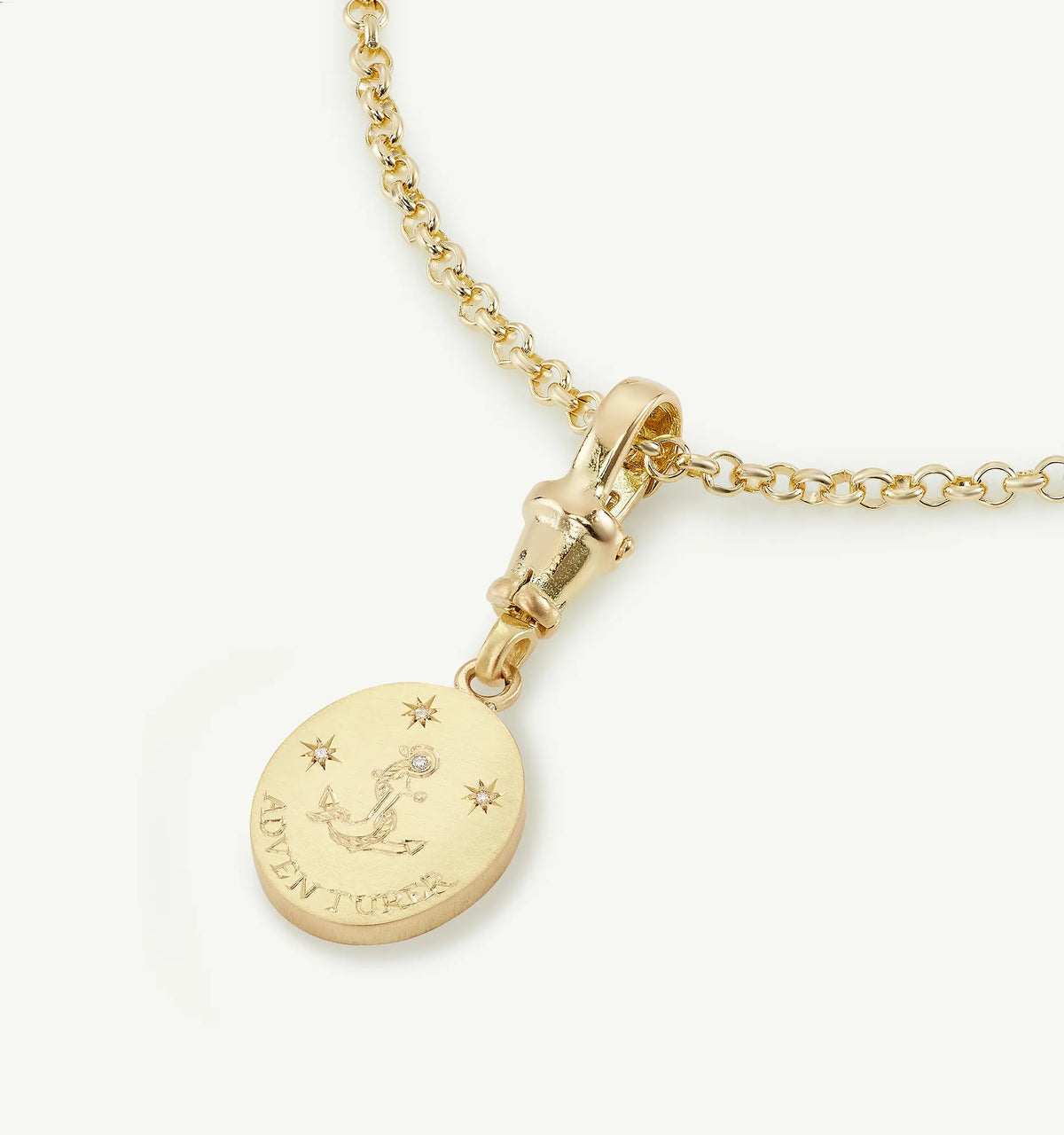 Gold pendant necklace featuring an engraved anchor design and small star motifs.