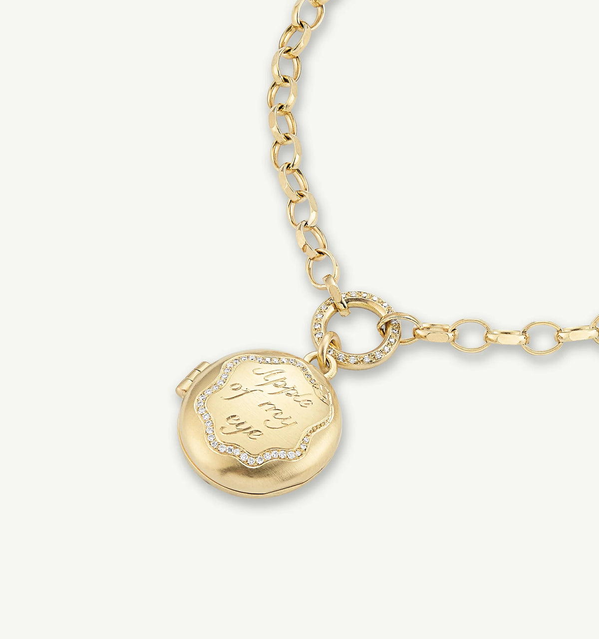Gold locket pendant featuring an engraved message, attached to a gold chain with circular links.
