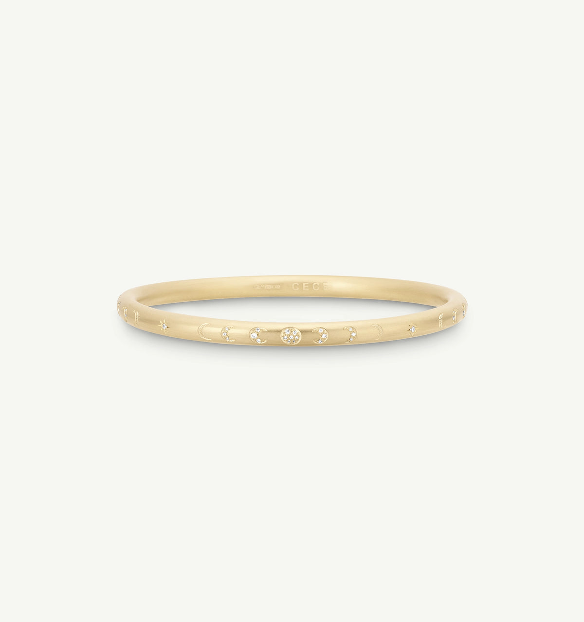 Gold bangle featuring engraved moon phases and a central diamond accent.