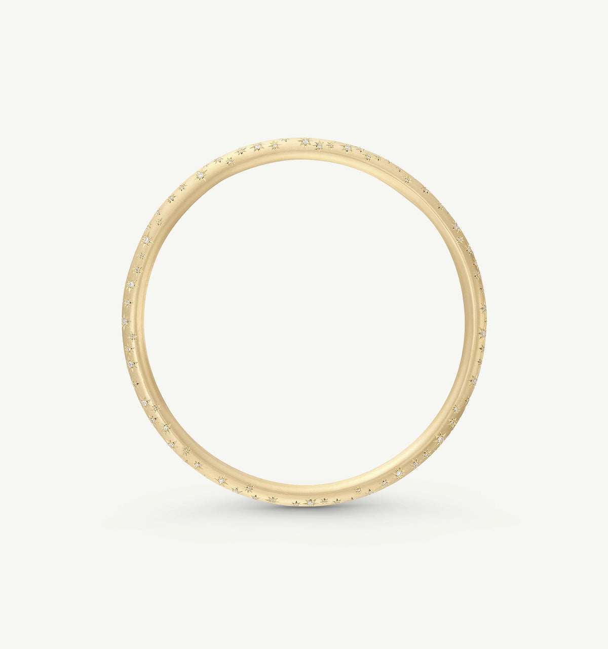Gold bangle featuring engraved star motifs and embellishments.