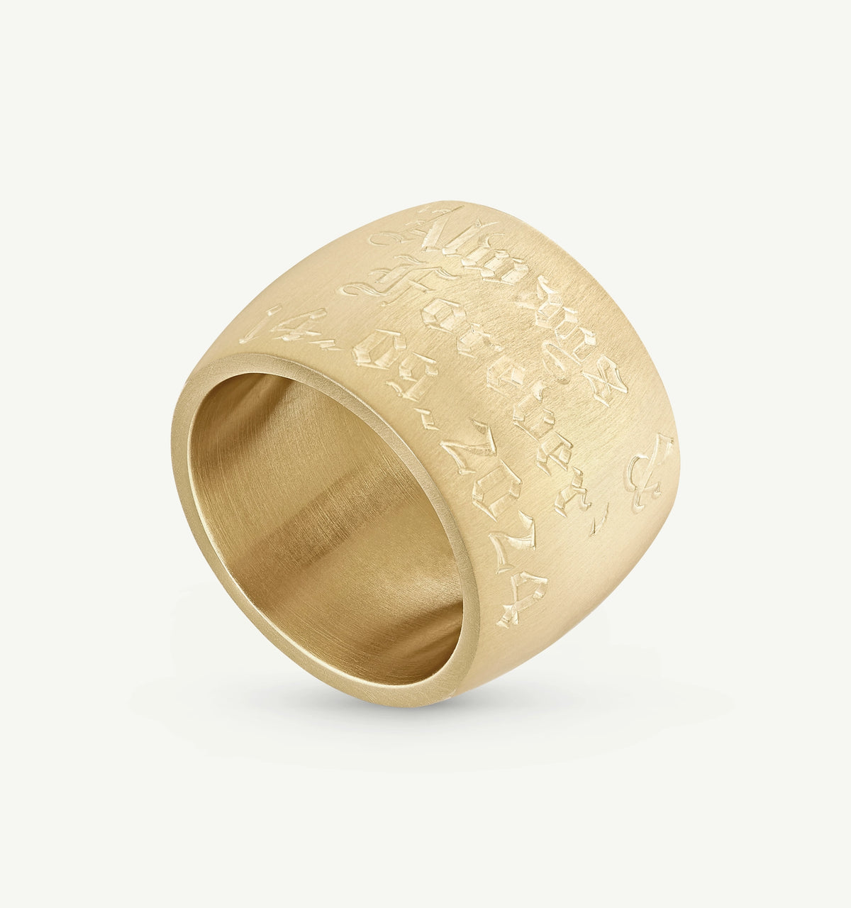 Gold signet ring featuring engraved text in a decorative script style.
