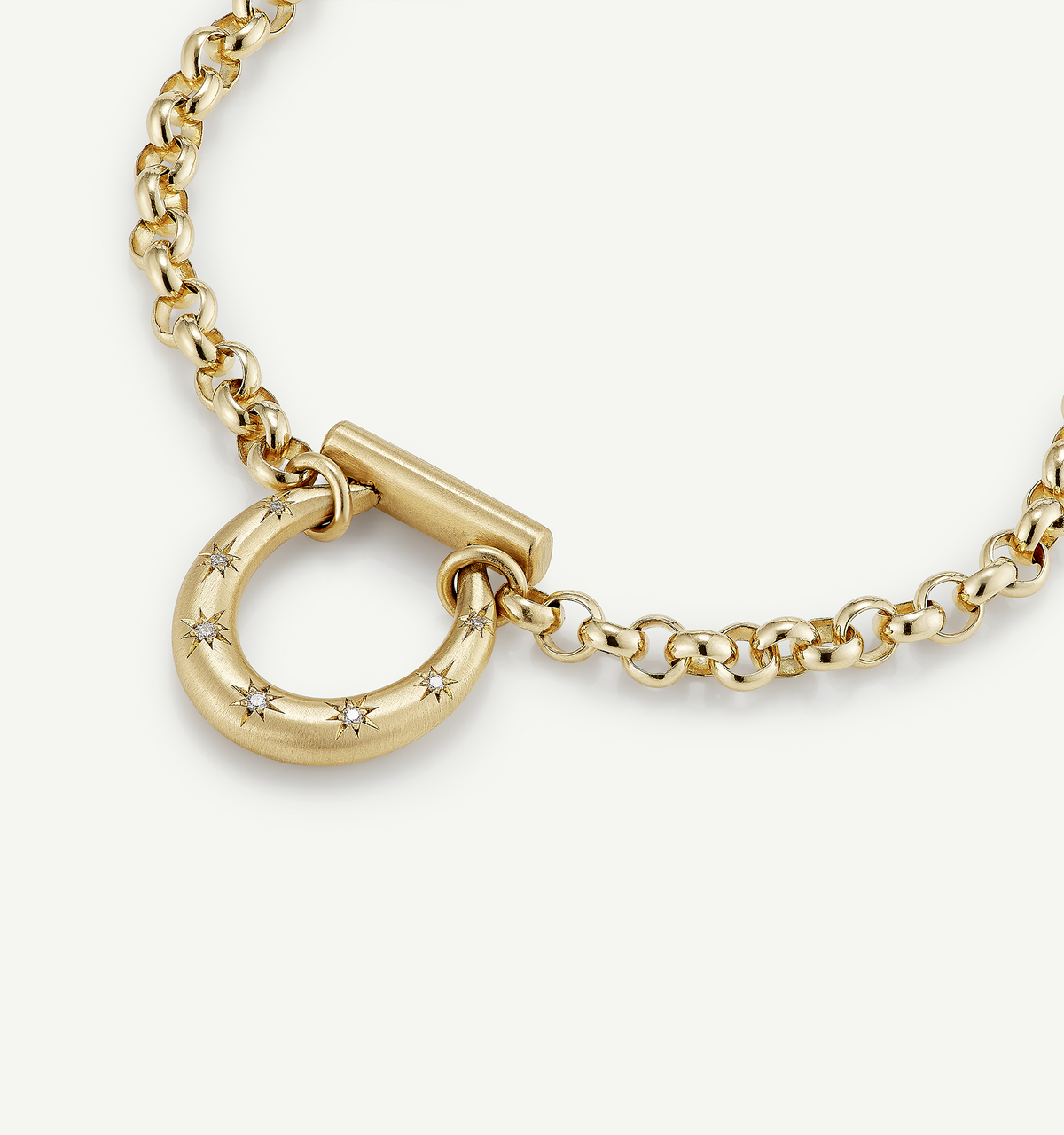 Gold chain necklace featuring a round pendant adorned with small star motifs.
