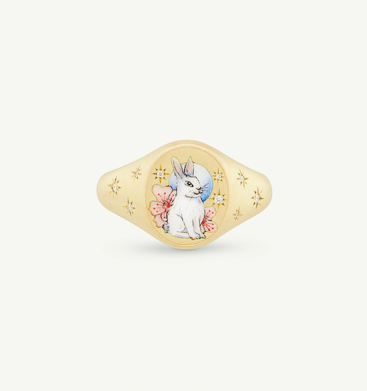 Gold ring featuring a hand-painted rabbit design surrounded by pink flowers and star motifs.