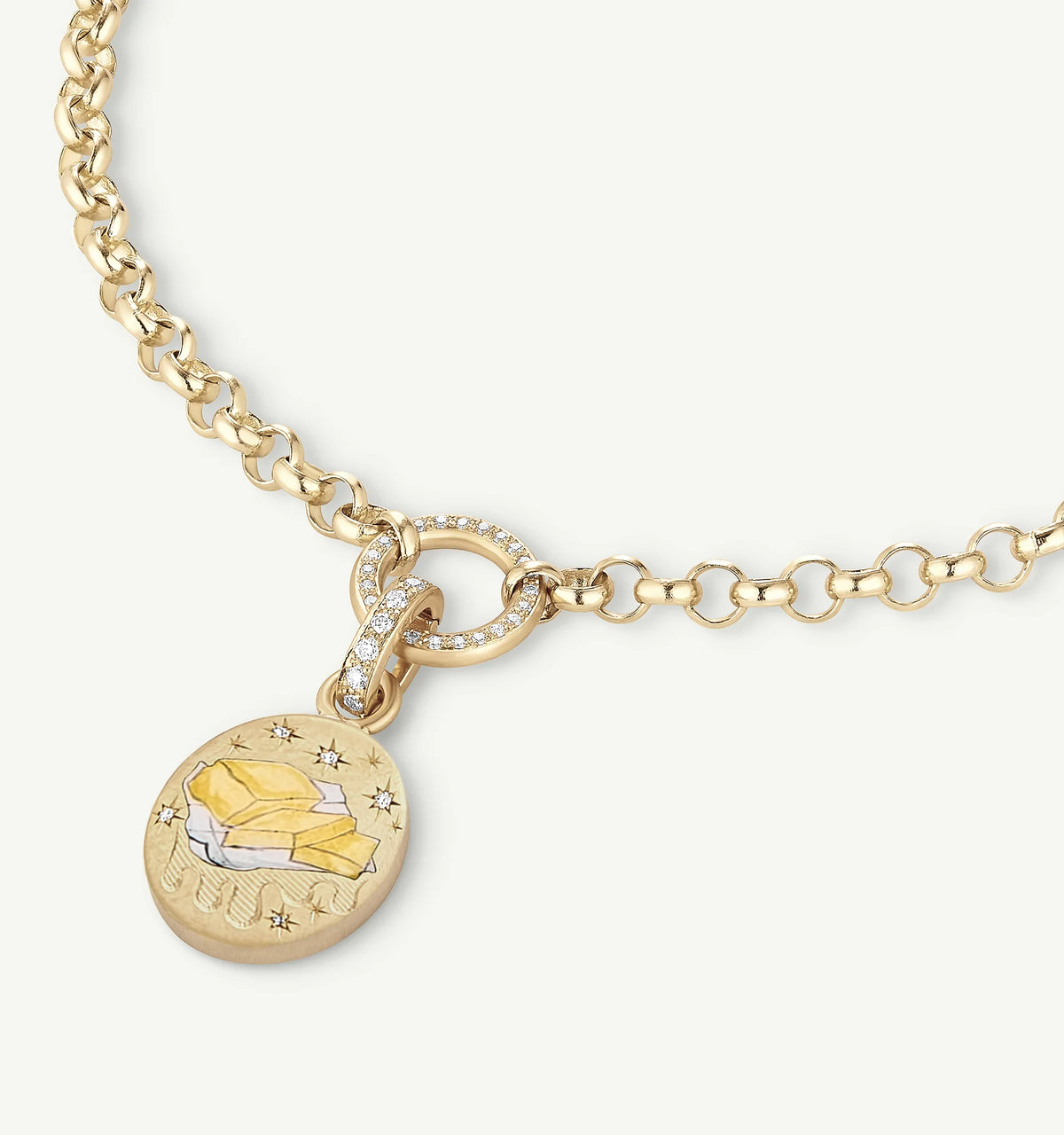 Gold chain necklace featuring an engraved pendant with a mountain design and small diamond accents.