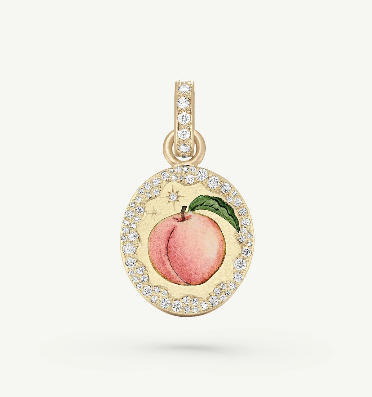 Gold pendant featuring a peach design with enamel and a diamond halo.