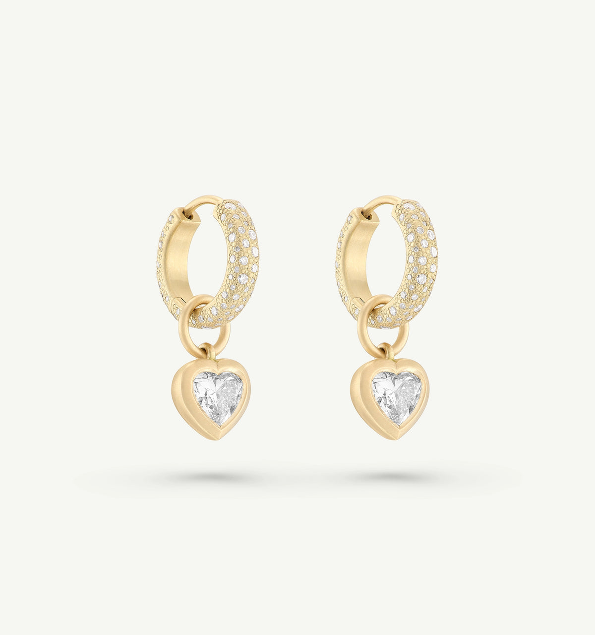 Gold hoop earrings featuring a heart-shaped pendant set with diamonds.
