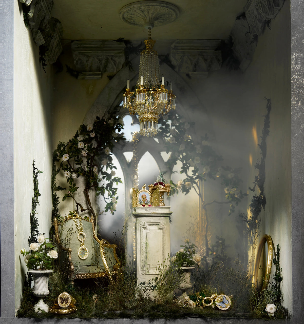 Gold jewellery display featuring a decorative pedestal, ornate mirror, and lush greenery in a dimly lit setting.