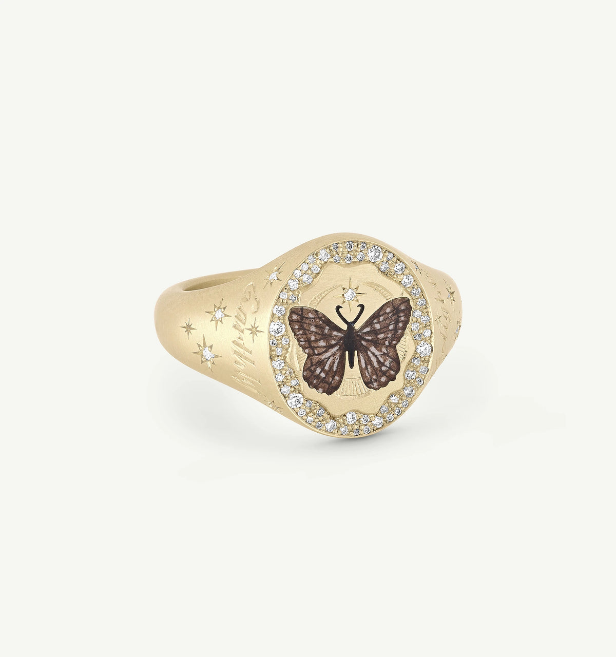 Gold signet ring featuring a butterfly motif and accented with clear diamonds.