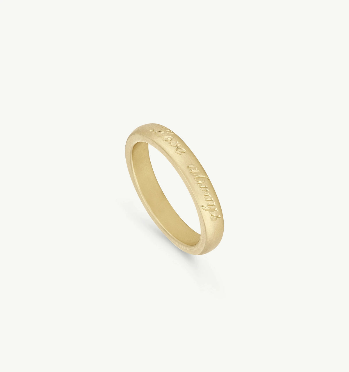 Gold ring featuring engraved text, displayed against a neutral background.