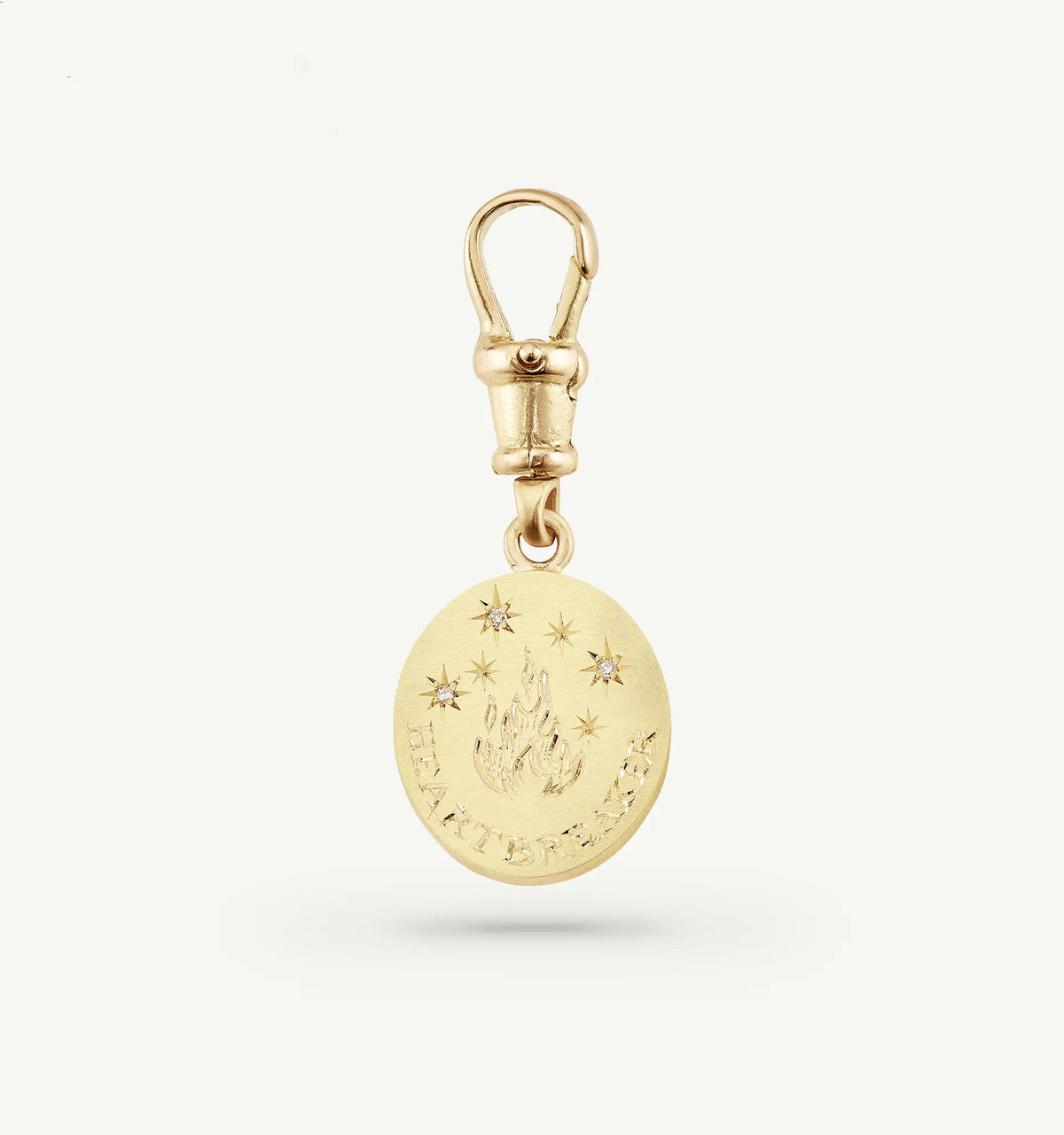 Gold pendant charm featuring a flame design and five diamonds, with the word "HEARTBREAKER" engraved.