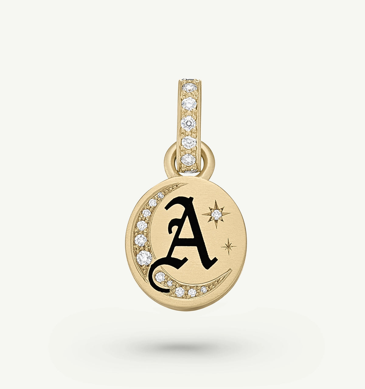 Gold pendant featuring an engraved letter "A" and decorative stars, accented with diamonds on the edge.