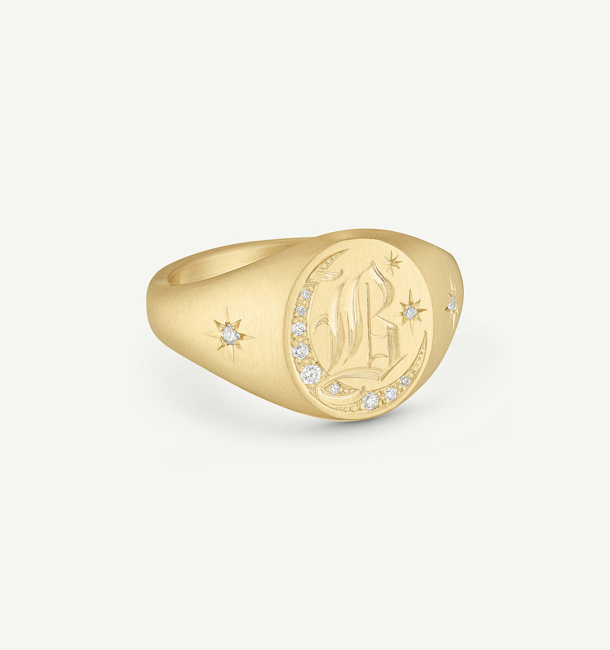 Gold engraved signet ring featuring diamonds and celestial motifs.