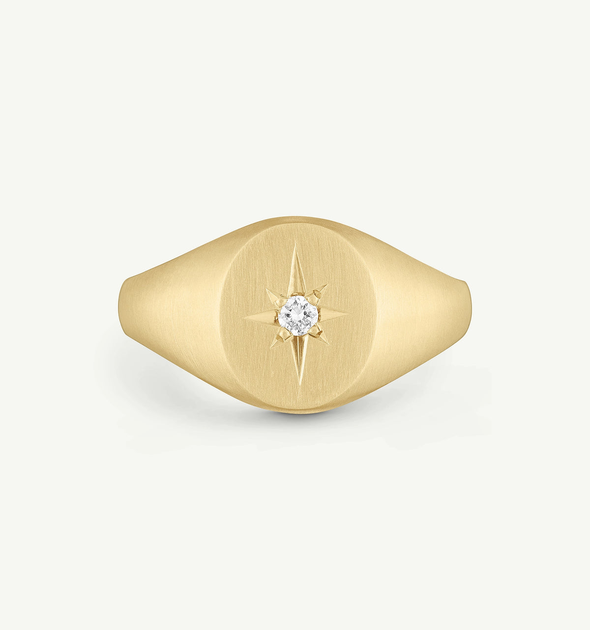Gold signet ring featuring a diamond accent in a star design.