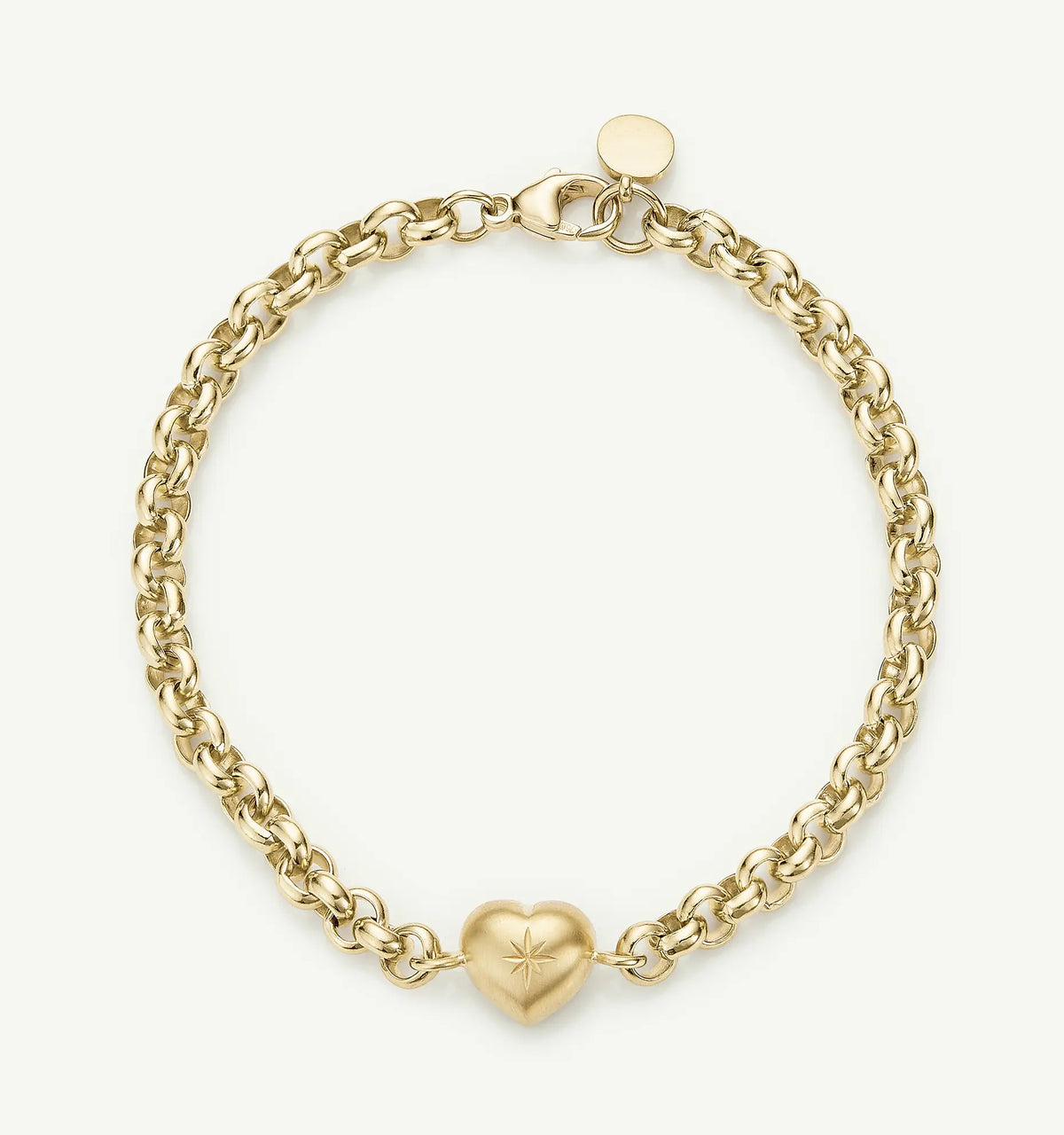 Gold chain bracelet featuring a heart charm with an engraved star design.