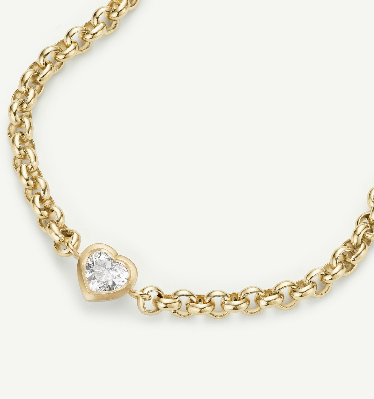 Gold chain bracelet featuring a heart-shaped setting with a diamond.