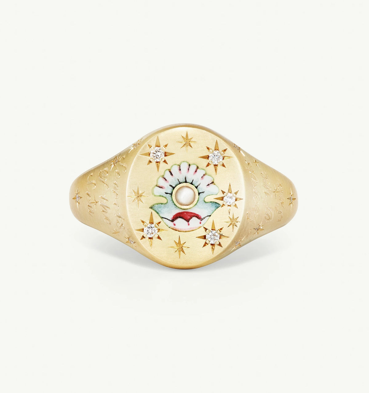 Gold ring with an engraved shell motif, featuring a pearl and diamond accents.