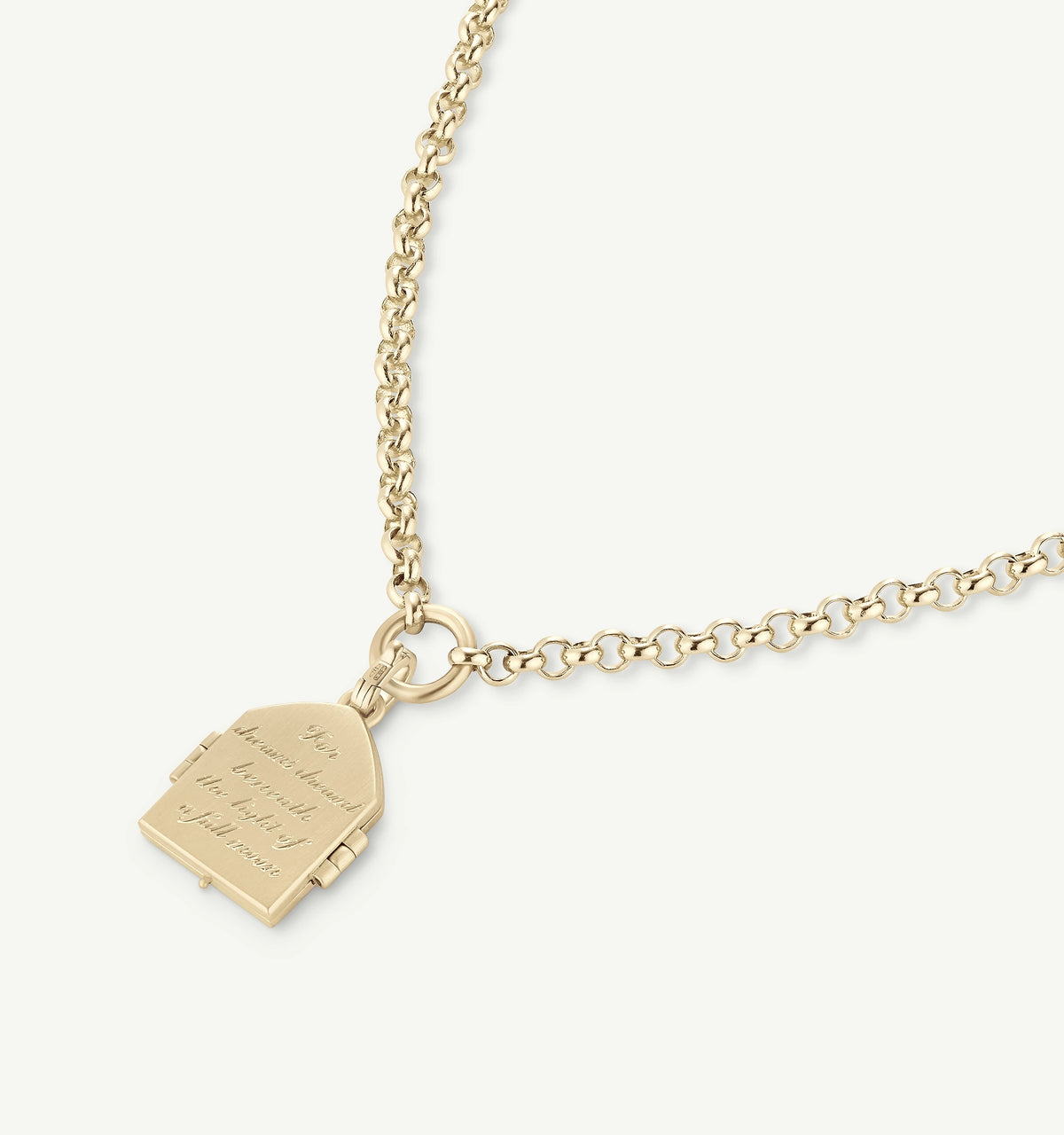 Gold necklace featuring a locket with an engraved message on a delicate chain.