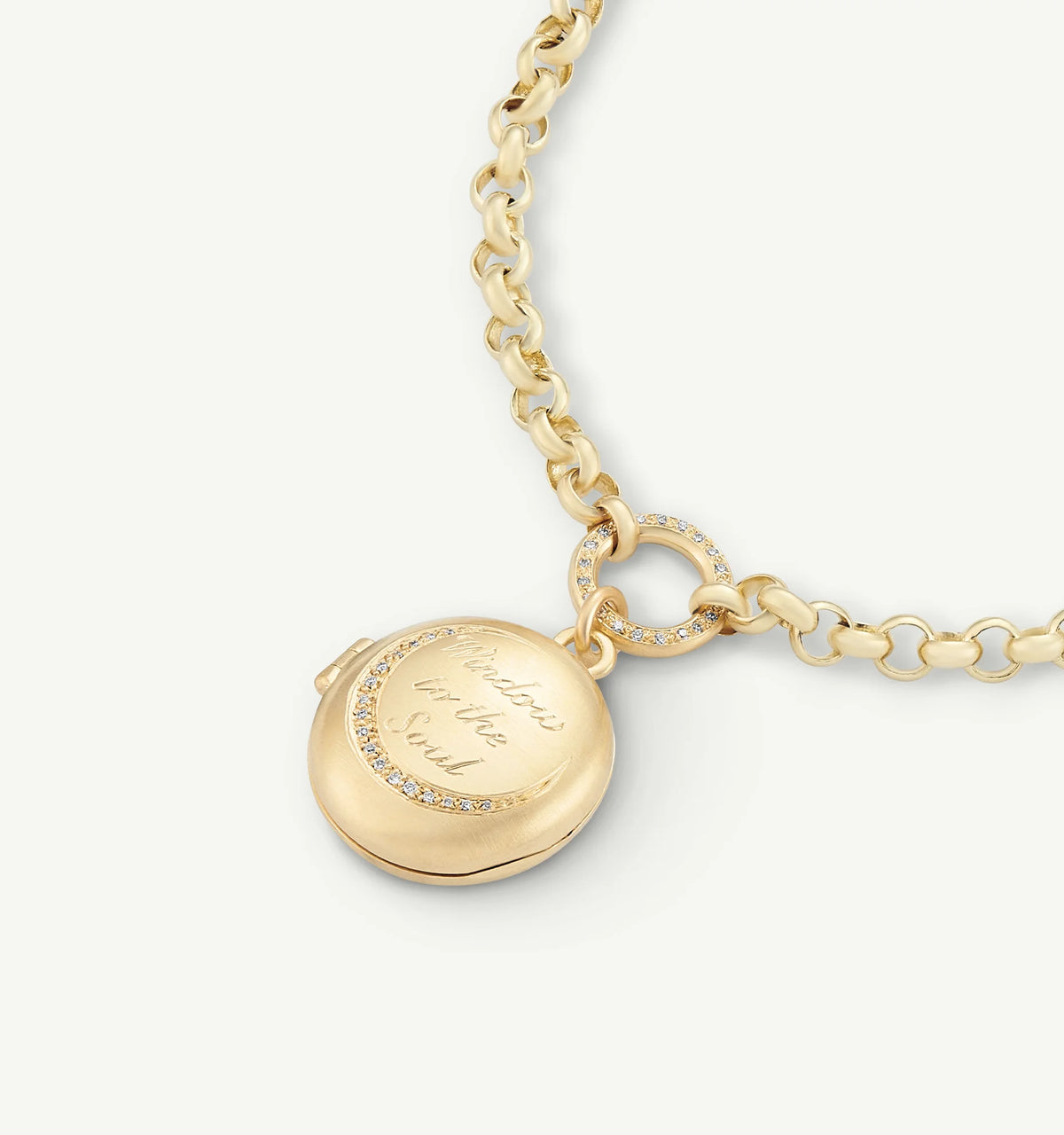Gold locket necklace featuring an engraved message and a gold chain with a circular link accent.