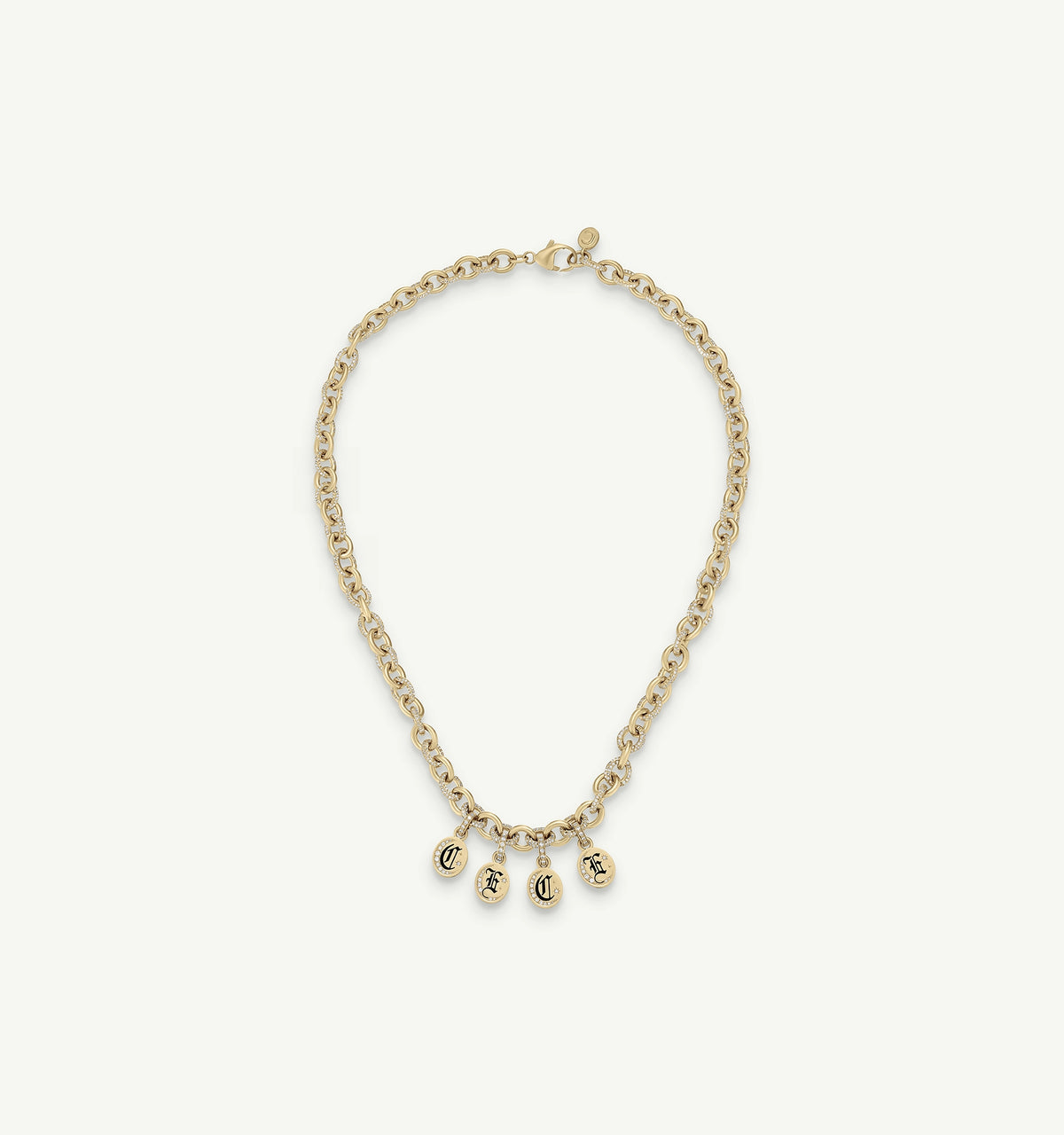 Gold chain necklace featuring four charm pendants with engraved letters.