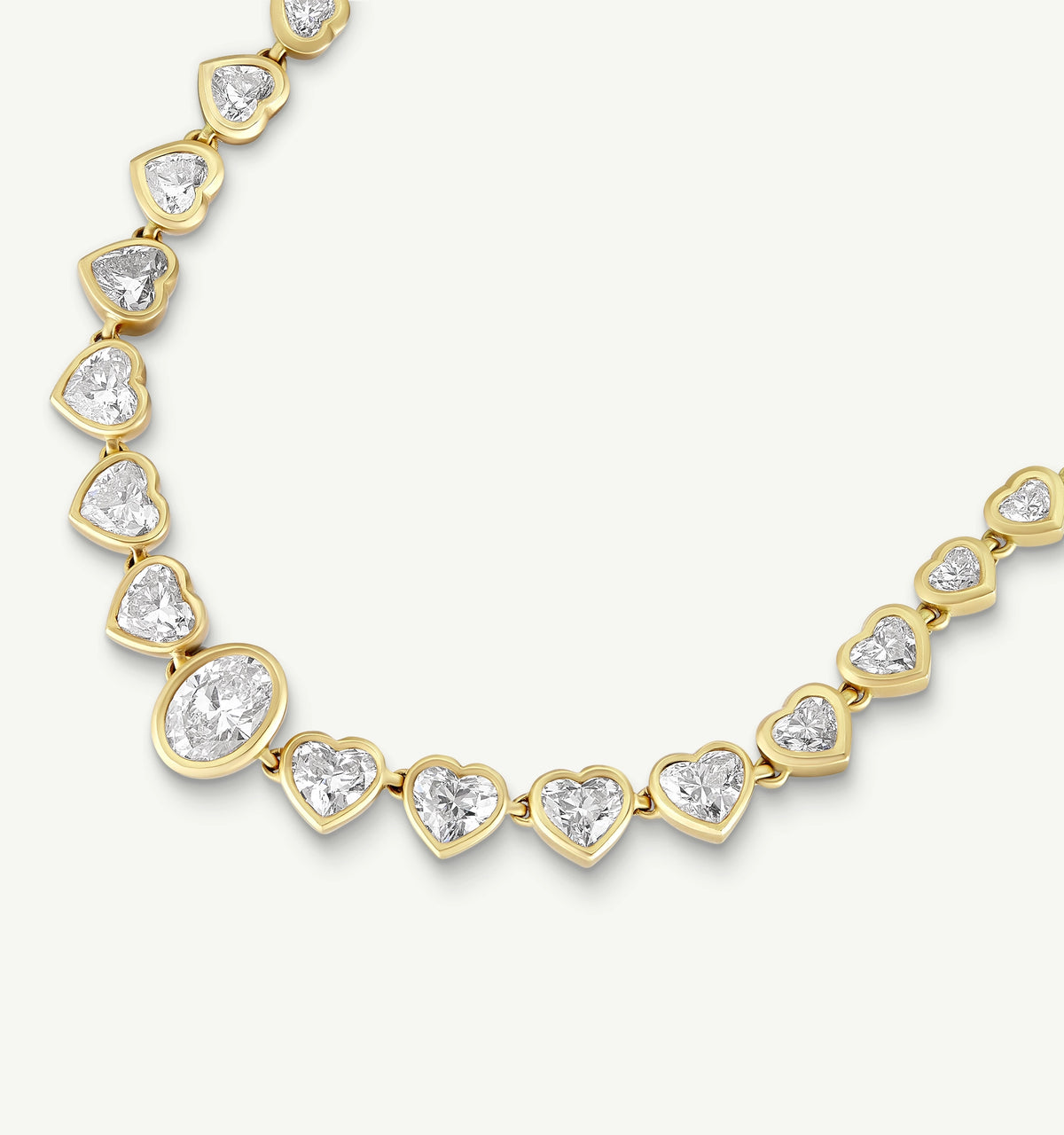 Gold necklace featuring heart-shaped diamonds in a prong setting.