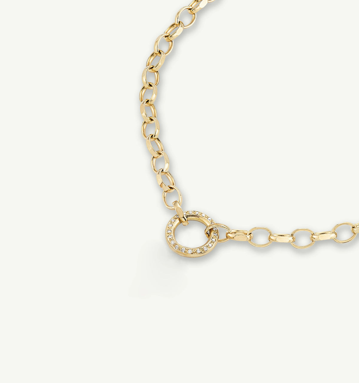 Gold chain bracelet featuring a circular clasp with diamonds.