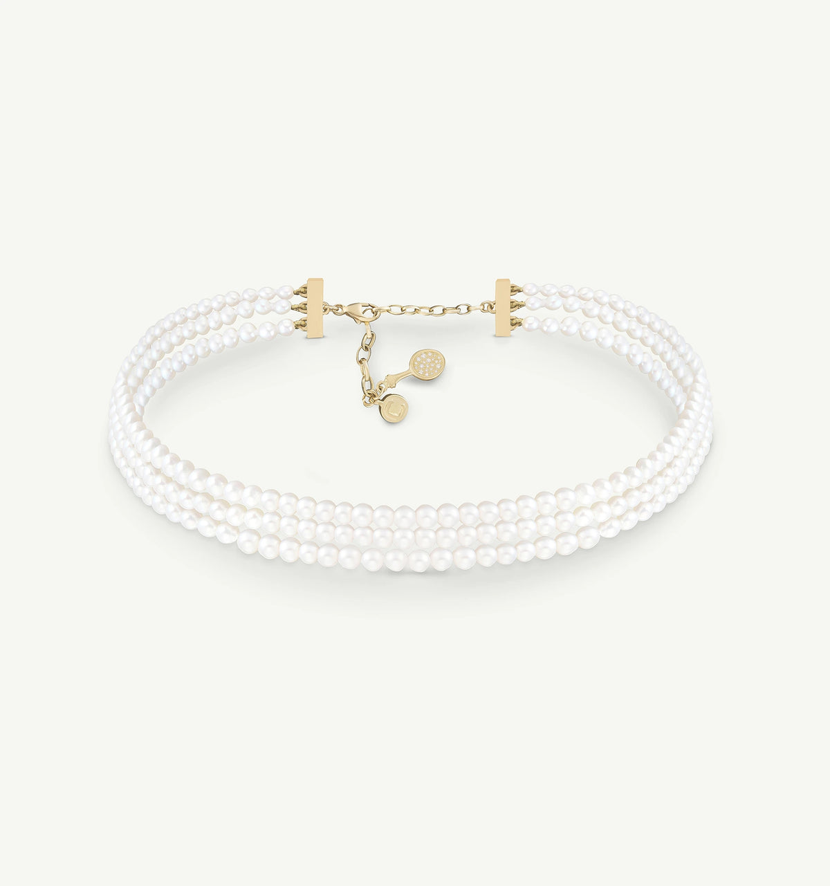 Gold bracelet featuring three strands of white pearls with a secure clasp.