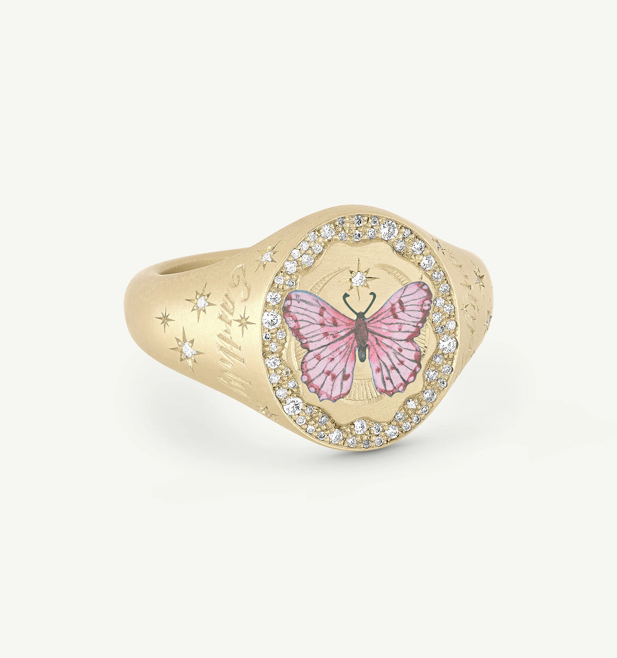 Gold ring featuring a pink butterfly motif in enamel surrounded by a circle of diamonds.