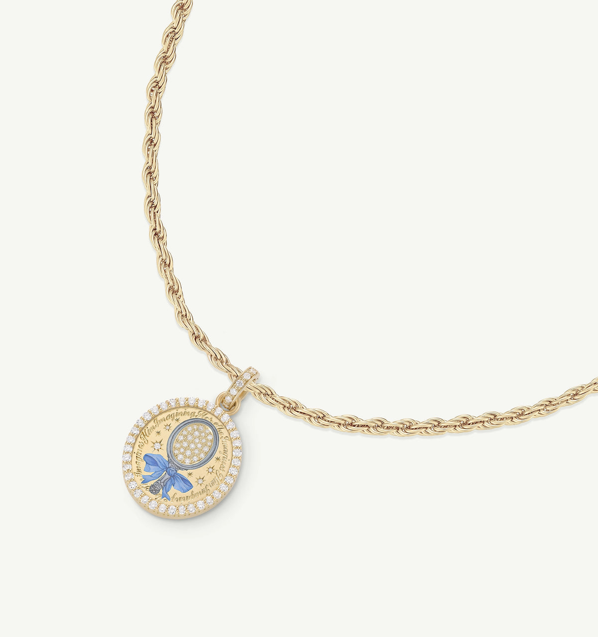 Gold necklace featuring a round pendant with a blue bow and embellished with enamel and gold accents.