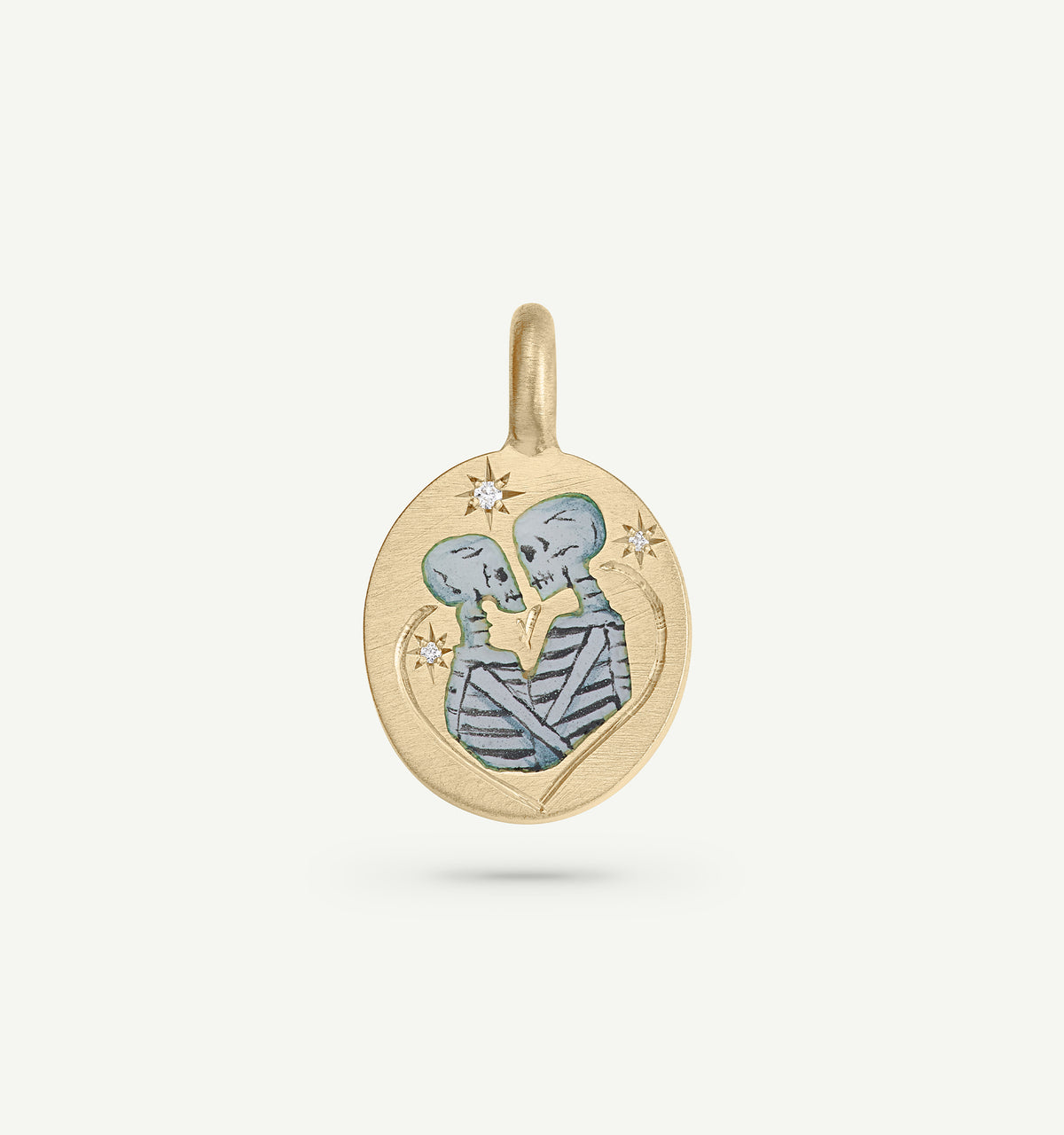 Gold pendant featuring engraved skeletons in an intimate embrace with decorative stars.