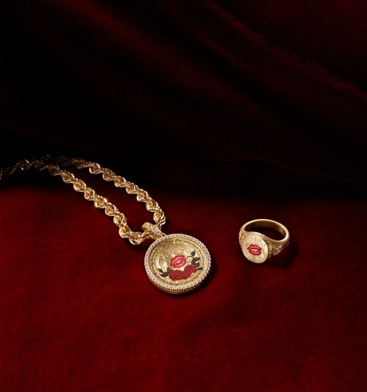 Gold chain necklace featuring a round pendant with a red lip and roses, alongside a gold ring with a similar design.