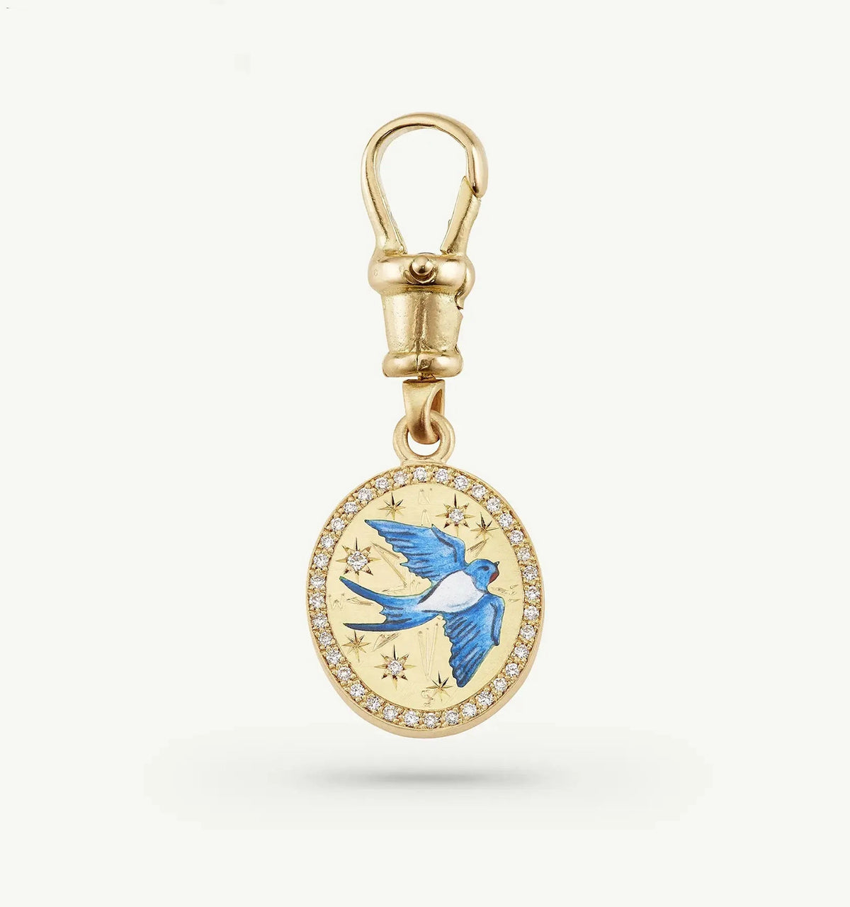 Gold charm featuring a blue bird design with enamel and surrounded by diamonds.