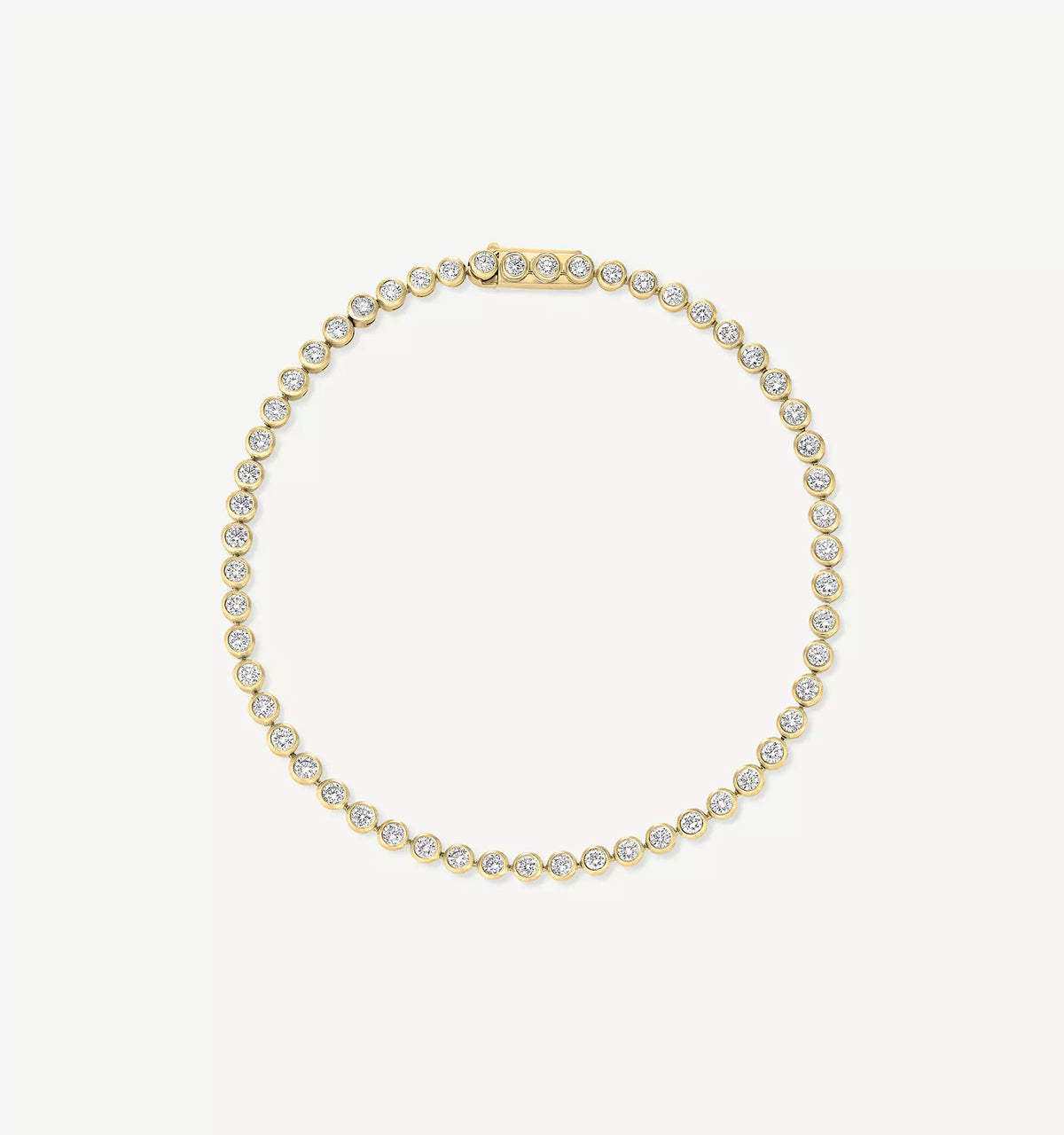 Gold bracelet featuring round diamonds set in a prong setting.
