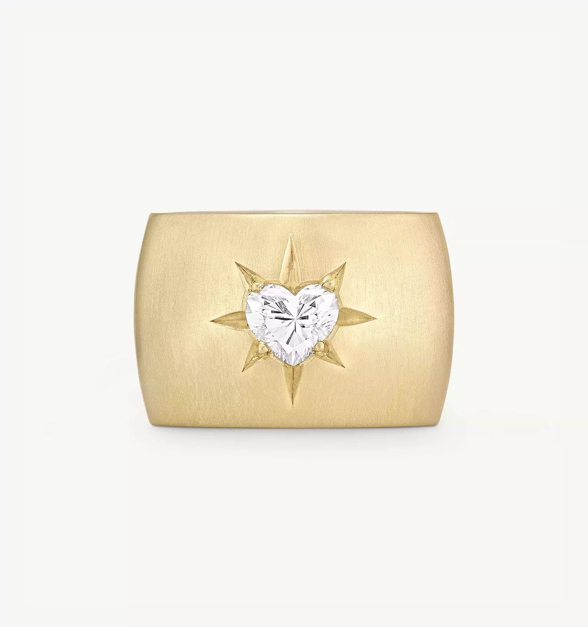 Gold ring featuring a heart-shaped diamond surrounded by a sunburst design.