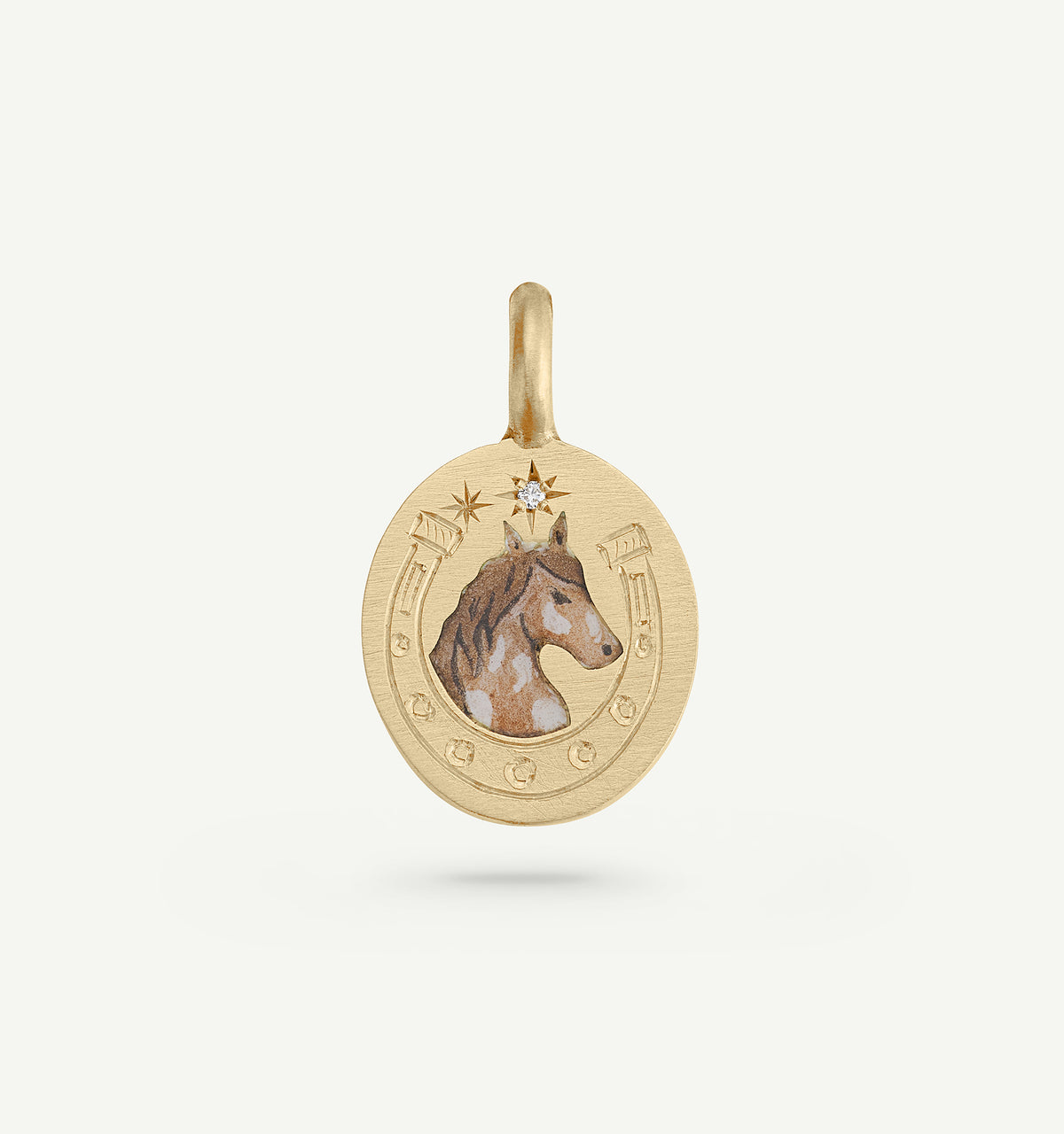 Gold pendant featuring a horse illustration in enamel and a small diamond accent.