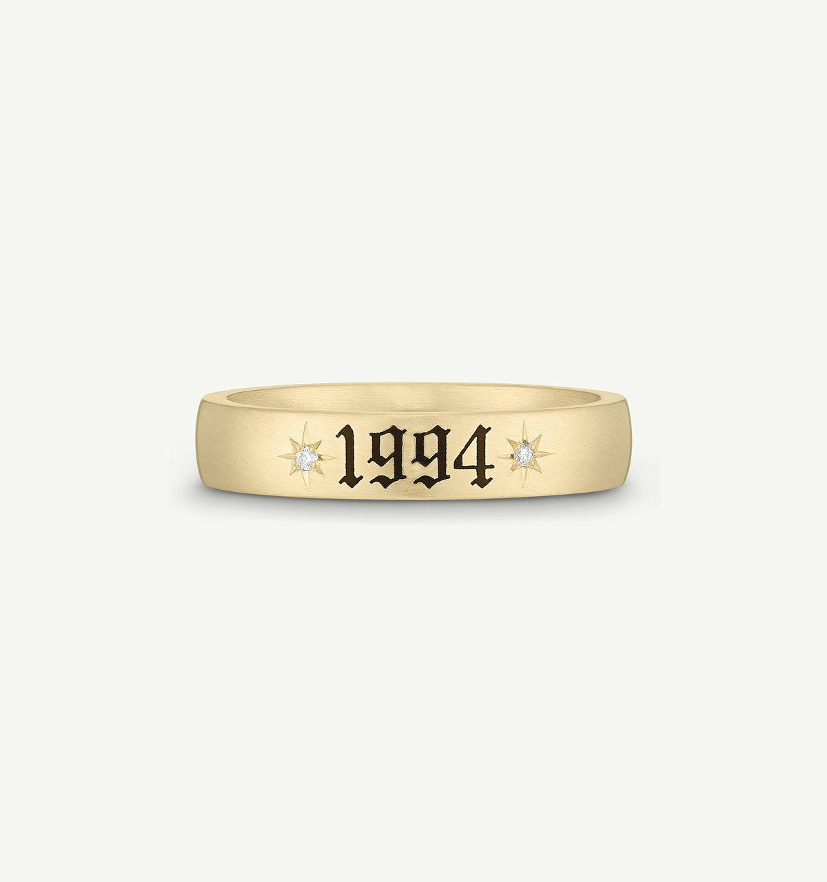 Gold ring featuring the year "1994" and two diamonds on either side.