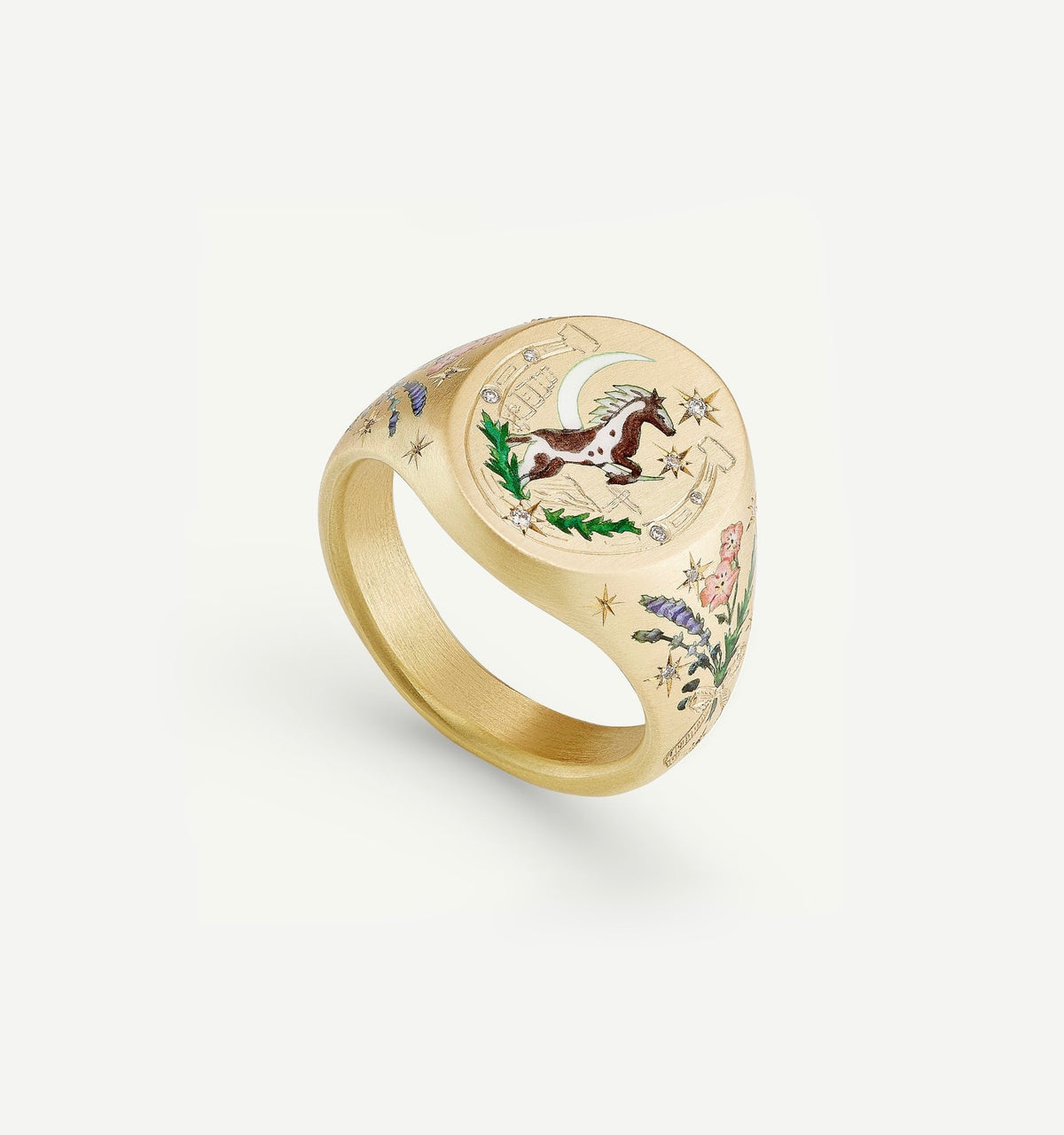 Gold ring featuring an intricately engraved horse, moon, and floral designs in colourful enamel accents.