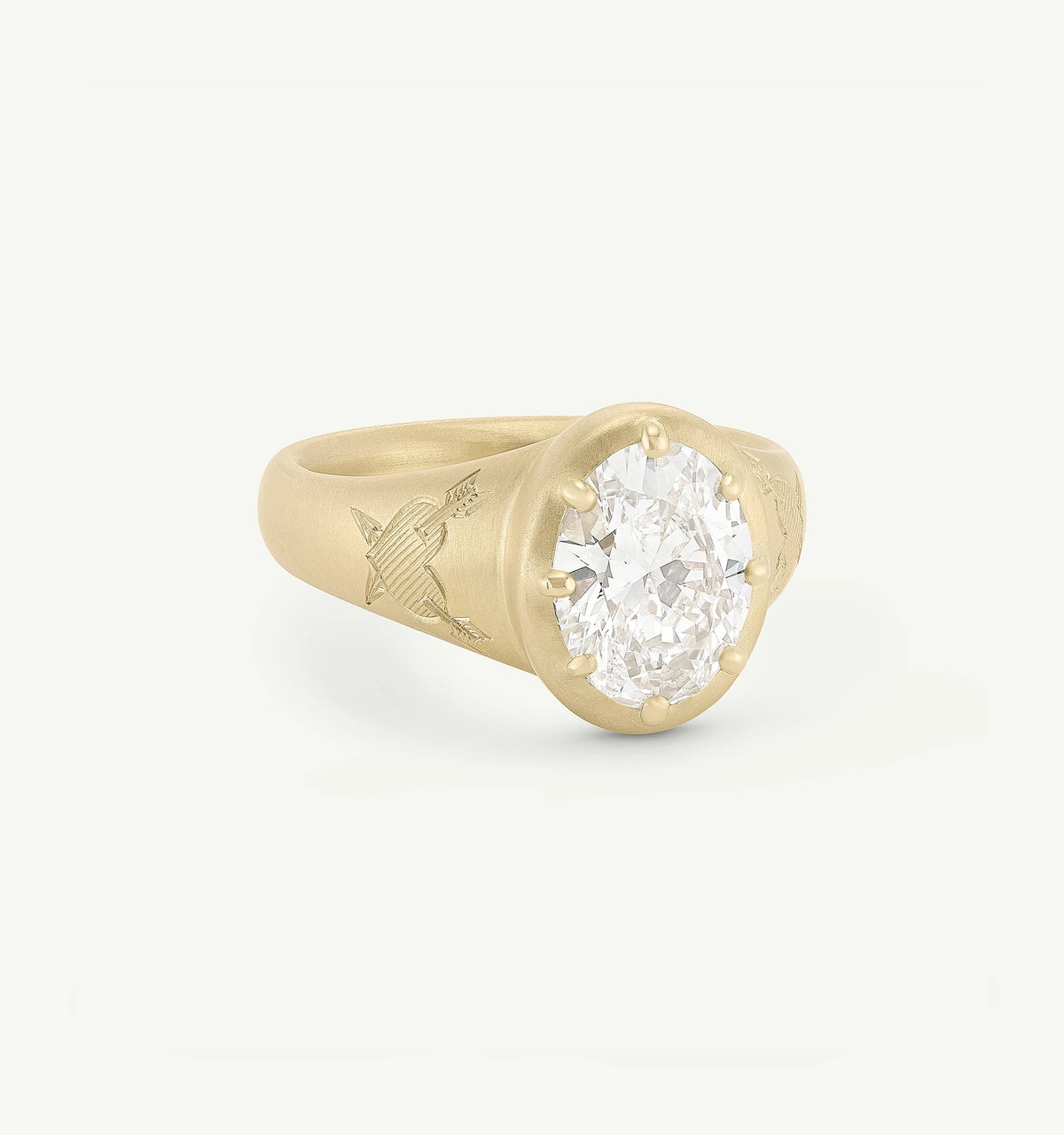 Gold ring featuring an engraved band and a large round diamond set in a six-prong design.