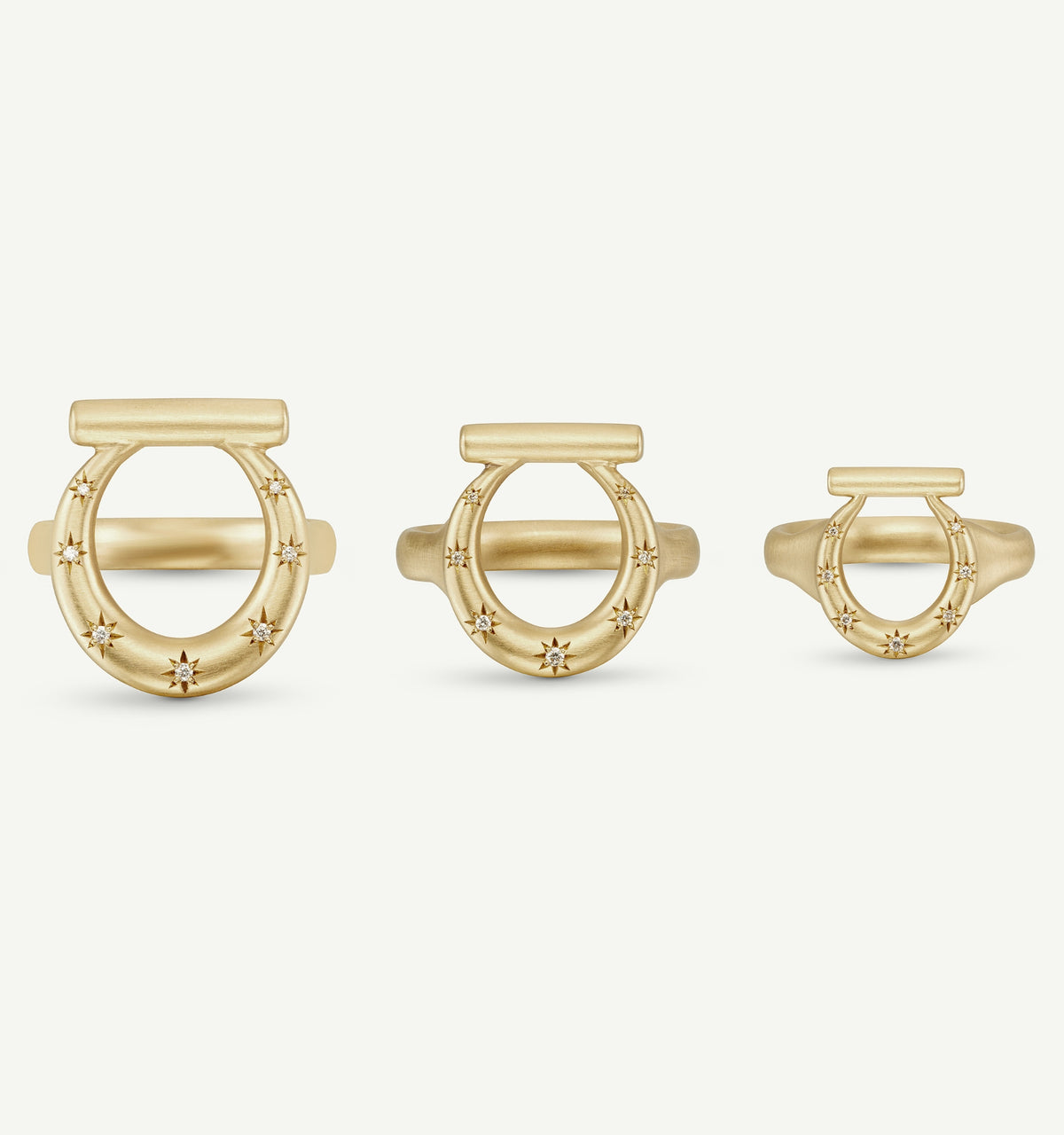 Gold rings featuring multiple stars, displayed in three sizes against a neutral background.