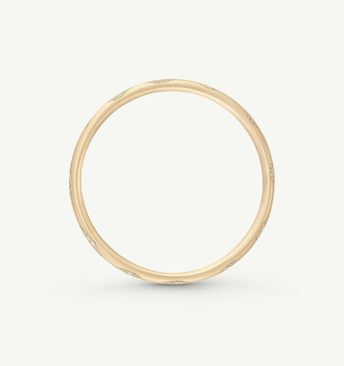 Gold bangle featuring textured surface details.