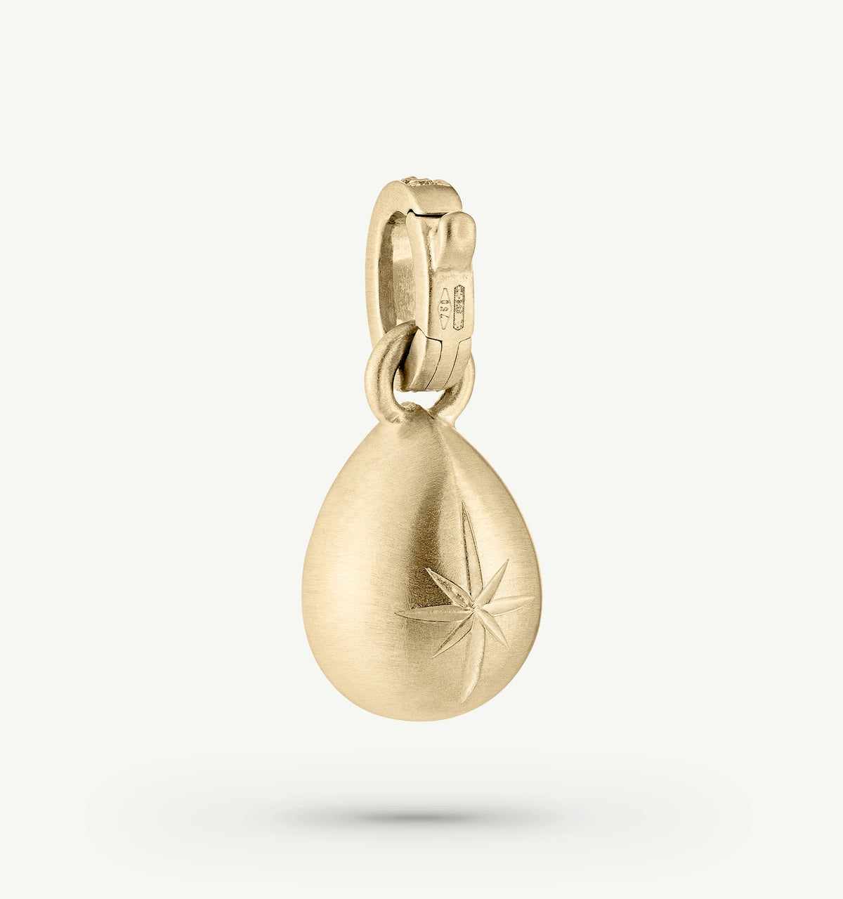 Gold pendant featuring a star engraving, designed with a teardrop shape and a brushed finish.