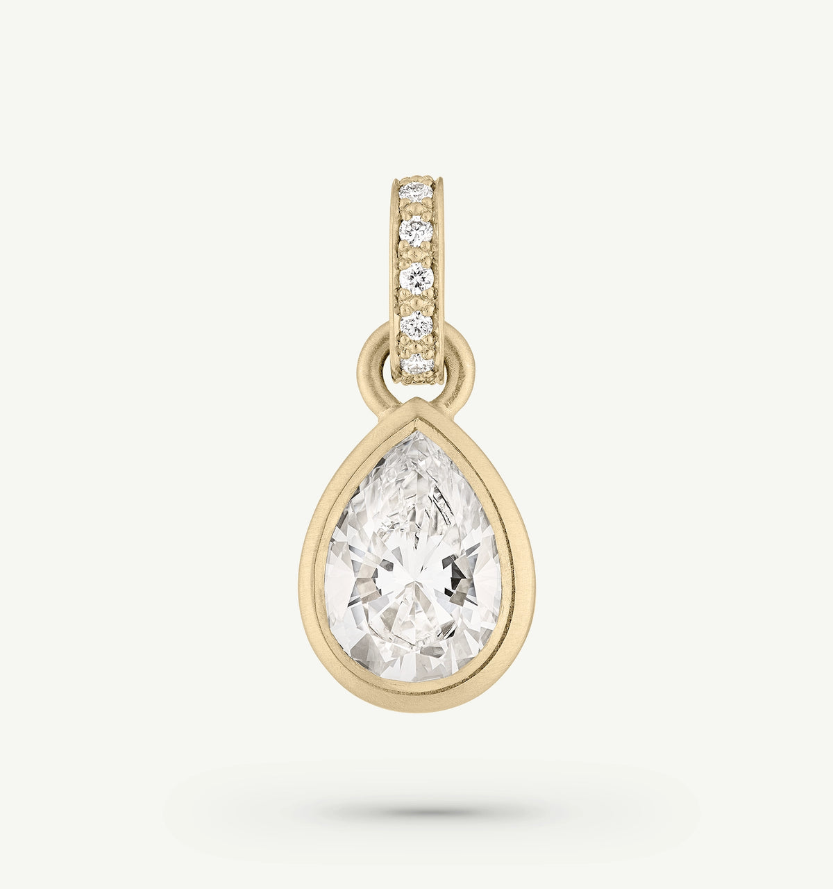 Gold pendant featuring a pear-shaped clear stone, adorned with a gold band set with small diamonds.