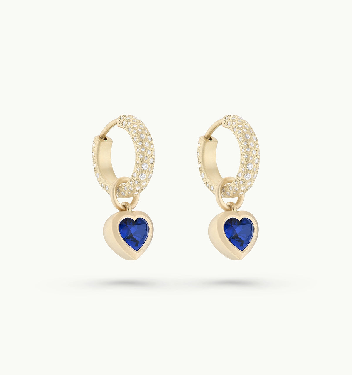 Gold hoop earrings featuring heart-shaped blue sapphires and diamonds.