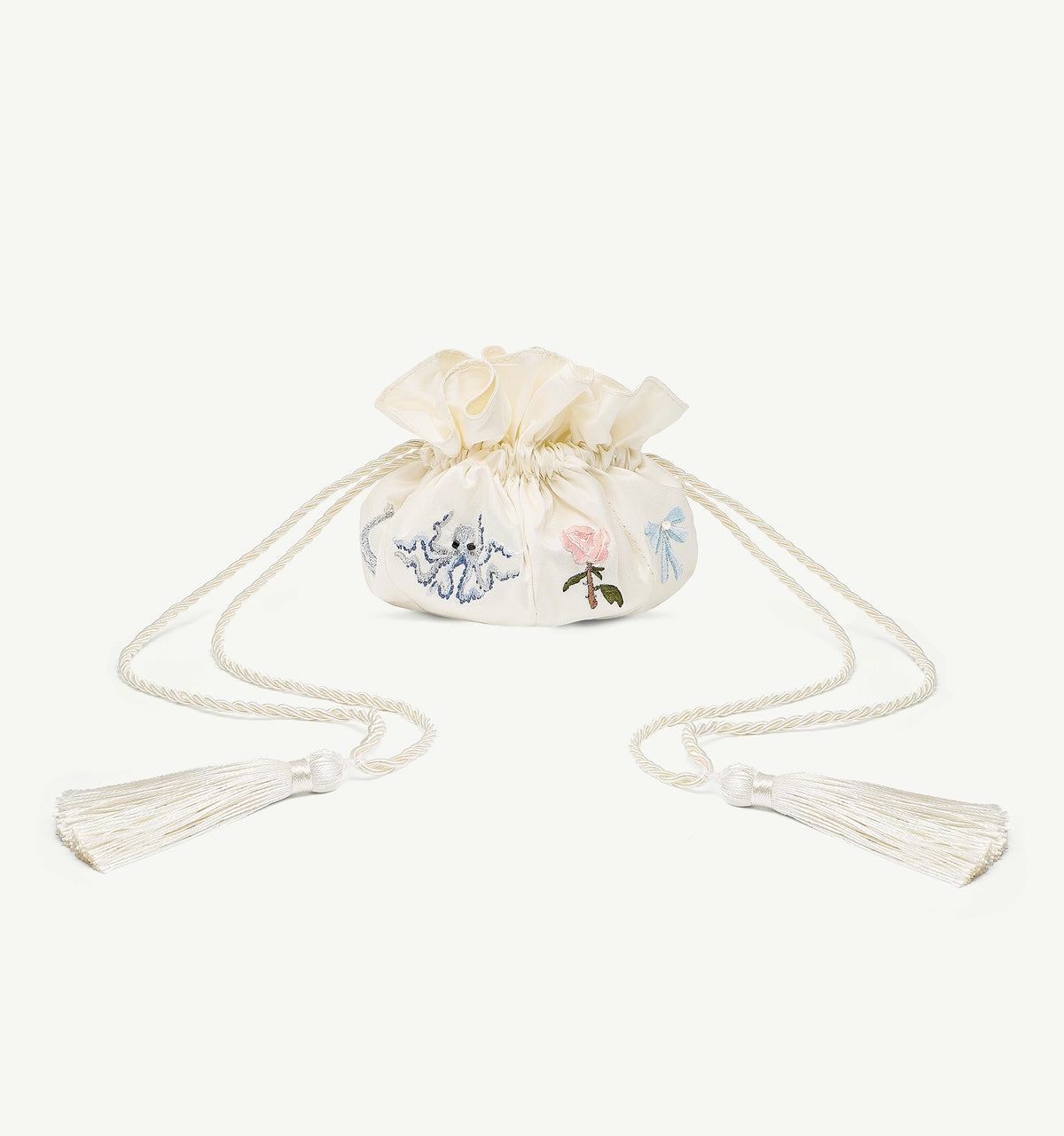 Small cream pouch with embroidered floral designs and tassels for storing jewellery.