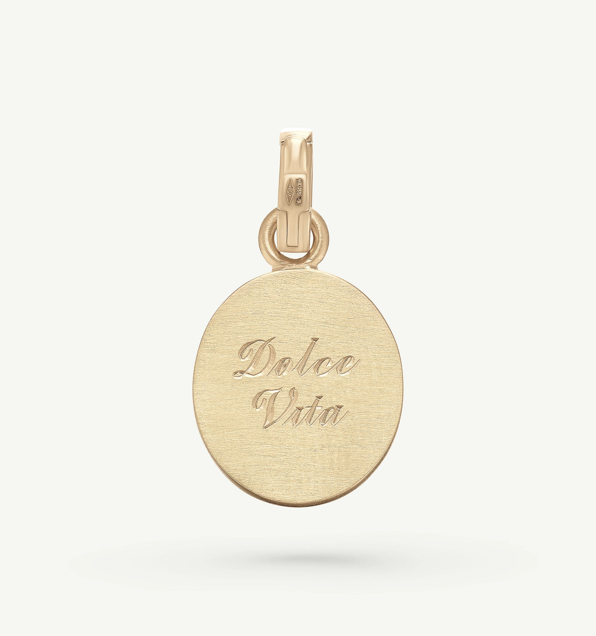 Gold pendant engraved with "Dolce Vita" on a brushed surface.