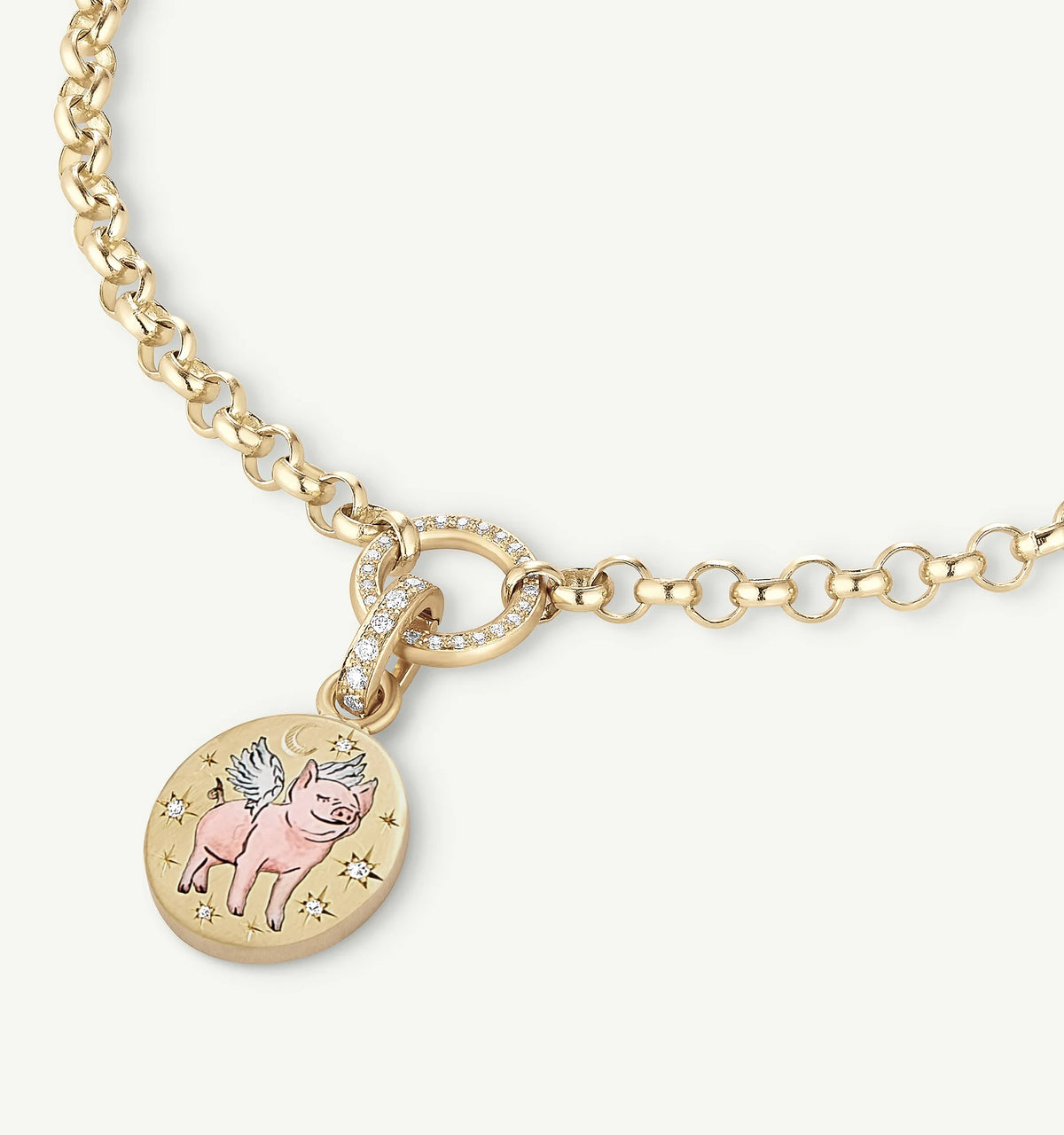 Gold necklace featuring a pendant with a pink winged pig design and diamonds.