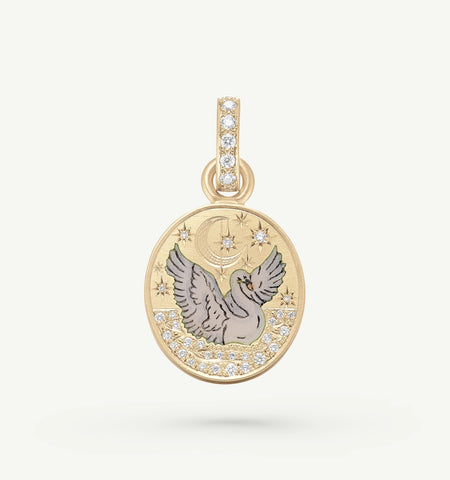 Gold pendant featuring a flying bird and moon design, accented with round diamonds.