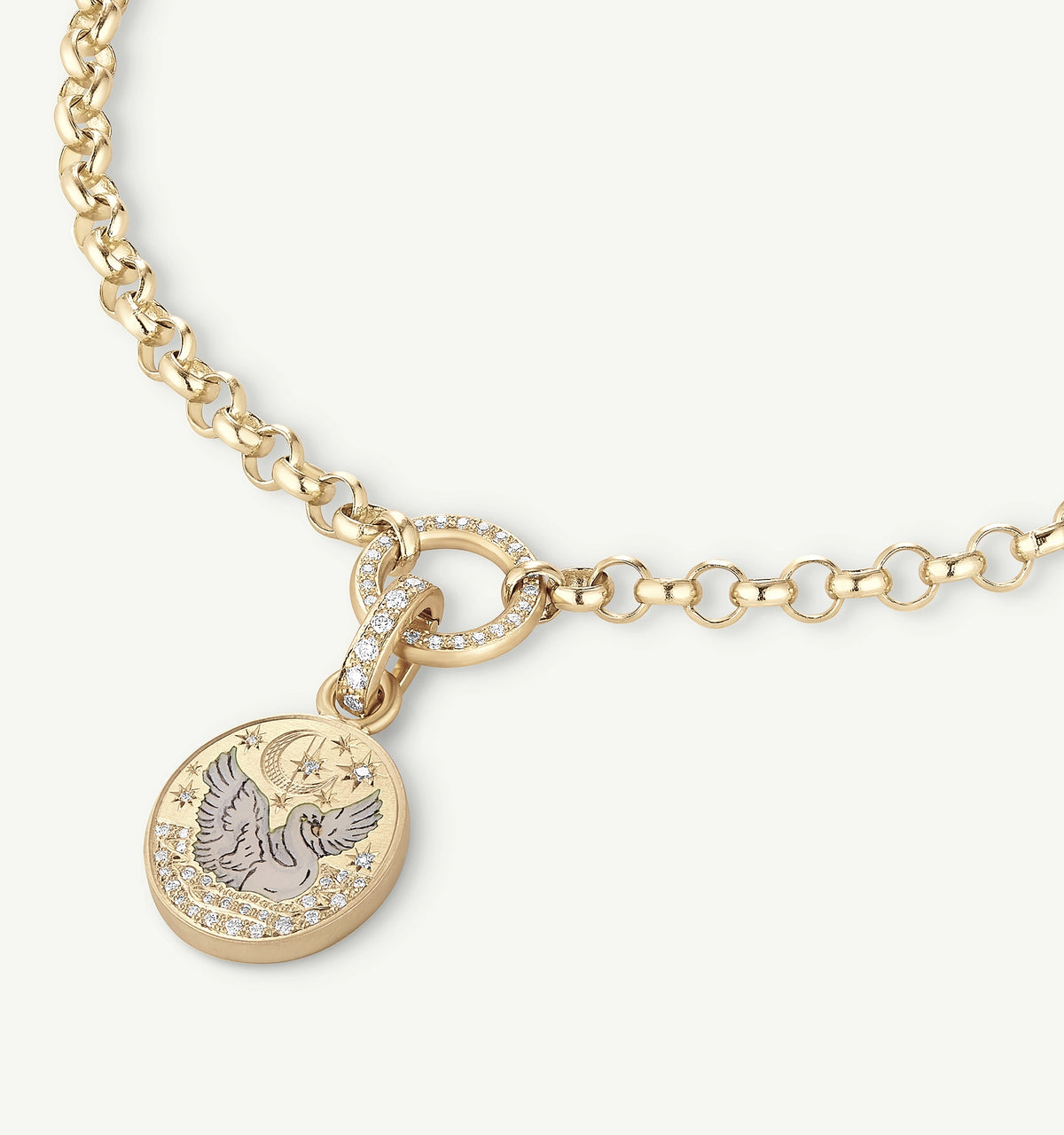 Gold necklace featuring a circular pendant with a flying bird design and diamonds.