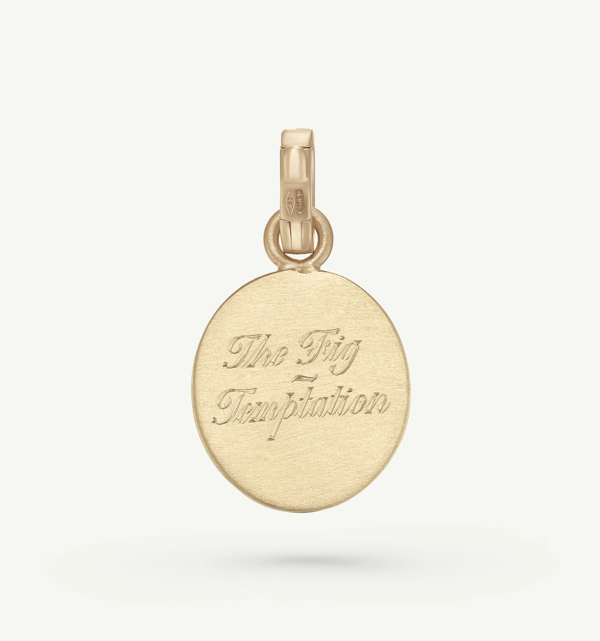 Gold pendant engraved with the phrase "The Fig Temptation."