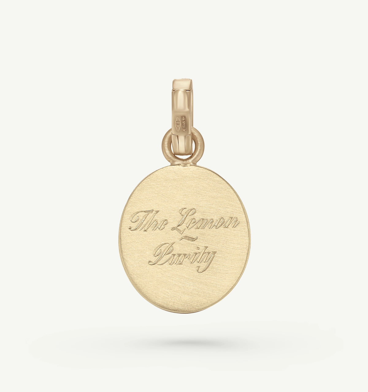 Gold pendant featuring engraved text "The Lemon - Purity" on a smooth surface.
